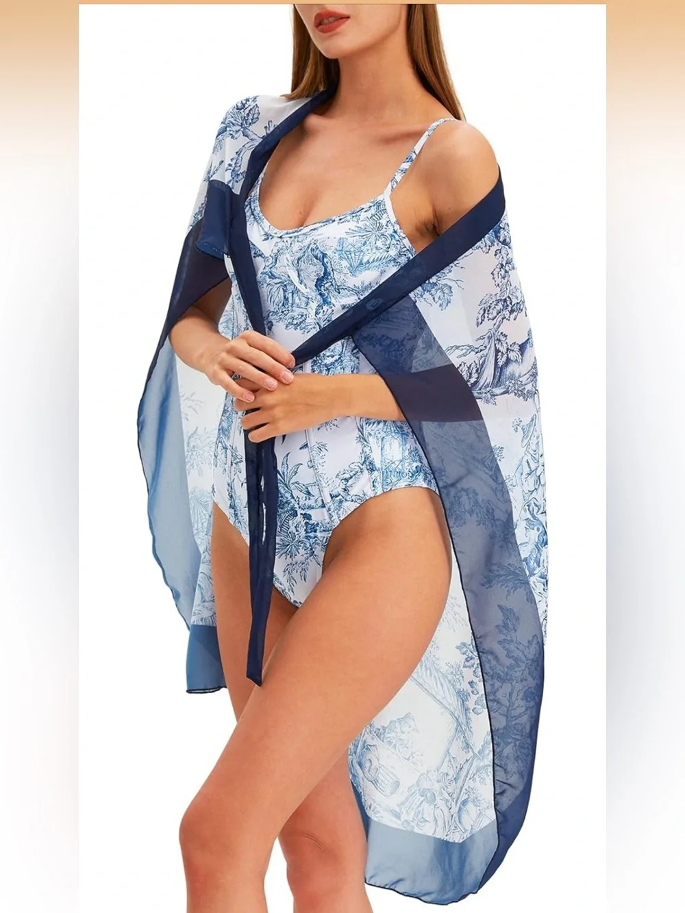 White and navy onepiece swimsuits with matching coverup.